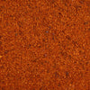 A detailed close up view shows the coarse texture and vibrant orange and red hues of Stubbs Grlc Lime E seasoning blend.