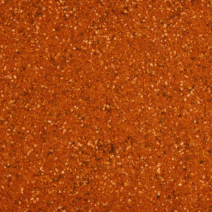 A close up overhead view shows the granular texture and rich reddish brown color of Stubbs Smkhouse E seasoning blend.