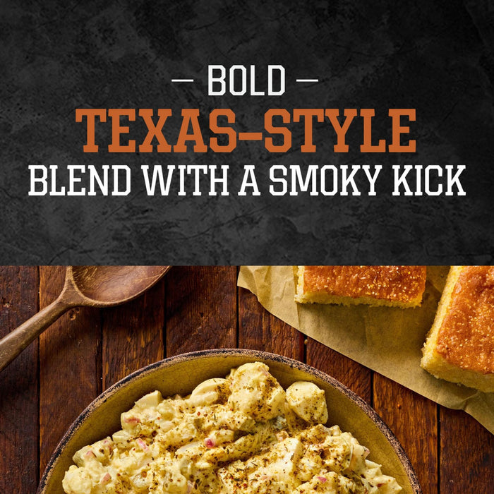 A bowl of creamy potato salad seasoned with Stubbs Hkry Must E is served alongside pieces of cornbread on a rustic wooden table, highlighting a bold Texas-style blend with a smoky kick.