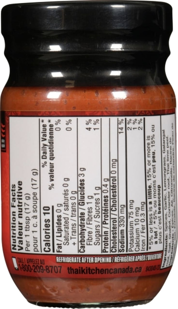 A jar of Thai Kitchen Red Curry Paste Curry 4 Oz, featuring a label that highlights its hot and vegan attributes, with visible nutrition facts and ingredients.