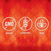 Three white circles with a red background and a damask pattern each circle has a different symbol and text: Non GMO Gluten Free Vegan.