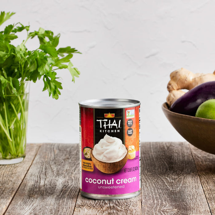A can of Thai Kitchen Coconut Cream, unsweetened, on a wooden table.