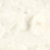 Close-up of creamy white ricotta cheese texture.