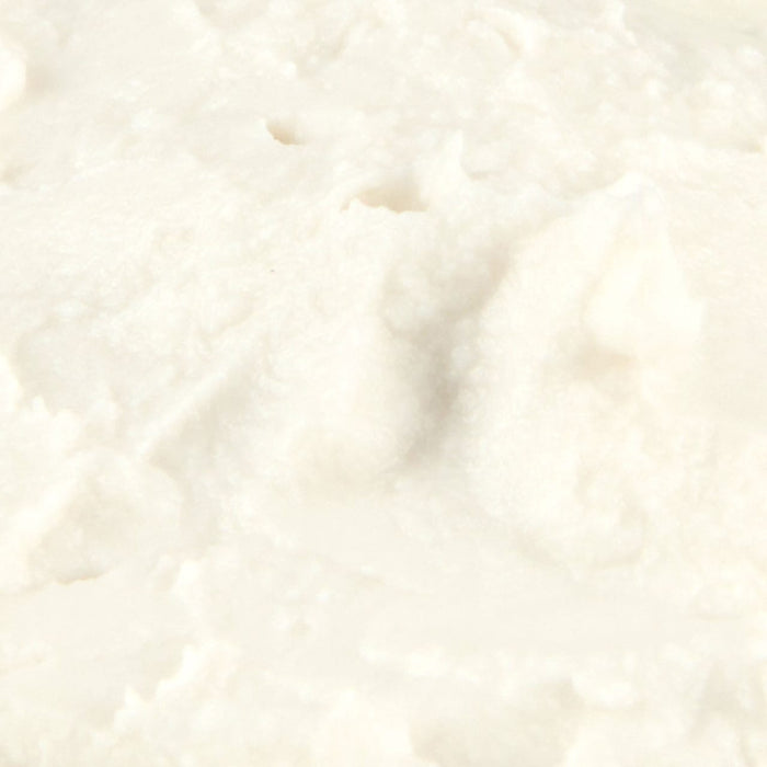 Close-up of creamy white ricotta cheese texture.
