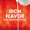 White text on a red background with a white liquid pouring down the center reads Rich Flavor Silky Smooth Texture