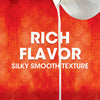 White text on a red background with a white liquid pouring down the center reads Rich Flavor Silky Smooth Texture