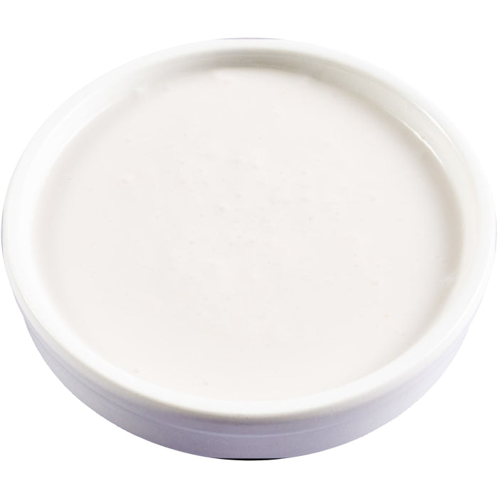 A bowl filled with a smooth, white substance, possibly yogurt or cream.
