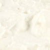 Close-up of a creamy, white, textured dairy product.