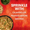 A finished dish made with Thai Kitchen, 9.0 Oz is shown in a black bowl next to bowls of cilantro and peanuts, with text suggesting to sprinkle them on top before serving.