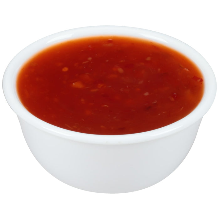 A white bowl filled with red sweet and sour sauce.