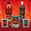 A collection of Thai Kitchen brand products including sweet chili sauce, fish sauce, coconut milk, red curry paste, and green curry paste are displayed against a red background.