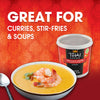 A container of Thai Kitchen red curry paste is featured alongside a bowl of soup with shrimp, highlighting its versatility for curries, stir-fries, and soups.