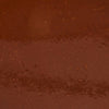 A close-up of a brown liquid with a grainy texture.