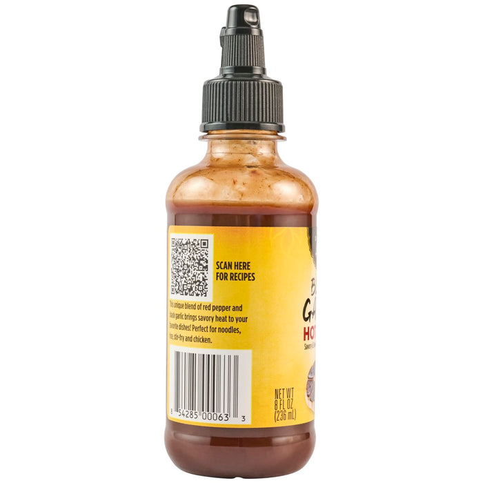 A bottle of Black Garlic Hot Sauce with a QR code to scan for recipes.