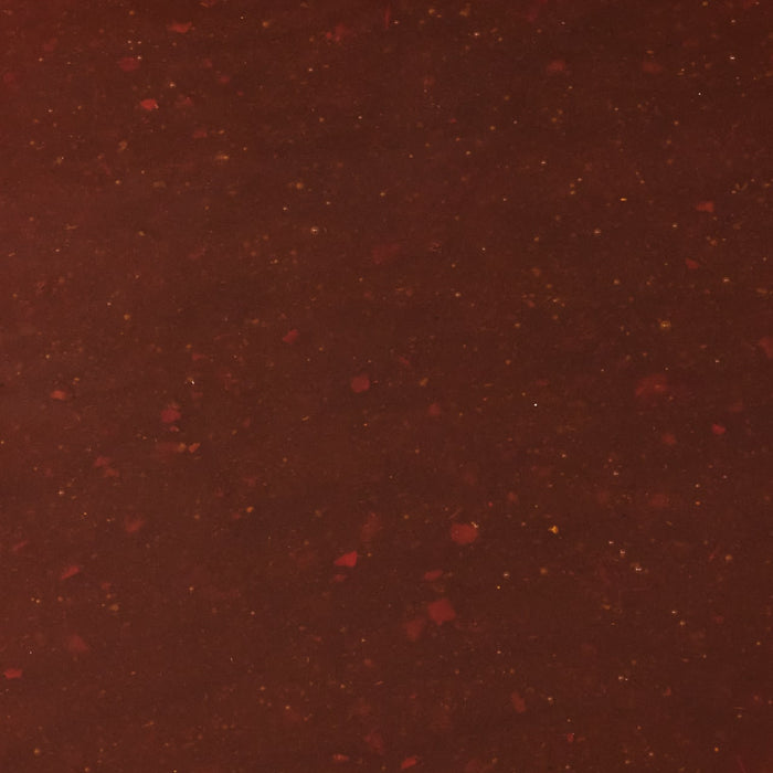 A close-up of a dark red sauce with small specks of red and yellow throughout.