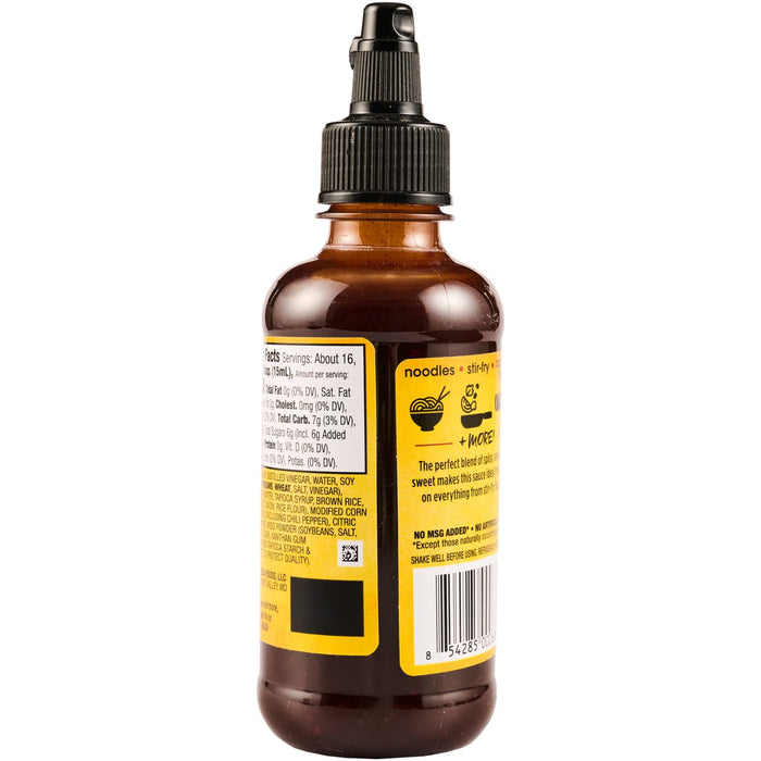 A bottle of  Kikkoman Teriyaki Sauce with a yellow label and a barcode.