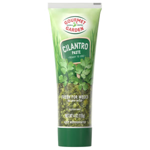 Gourmet Garden Cilantro Paste tube with a green background and cilantro leaves.