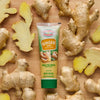 Gourmet Garden Ginger Paste tube surrounded by fresh ginger root.
