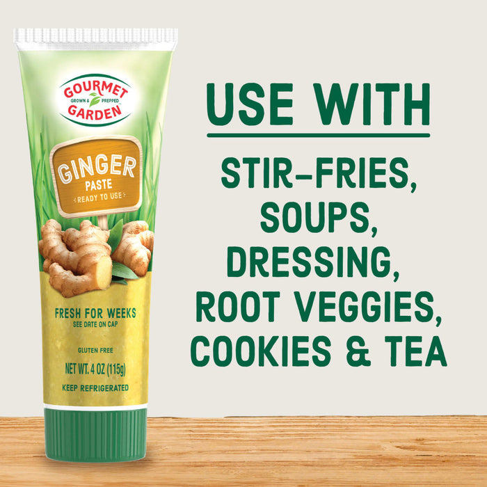 Gourmet Garden Ginger Paste tube with a wooden sign and ginger root on a wooden surface.