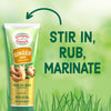 Gourmet Garden Ginger Paste tube with fresh ginger and a green background with the text 'Stir in, rub, marinate.'