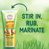 Gourmet Garden Ginger Paste tube with fresh ginger and a green background with the text 'Stir in, rub, marinate.'