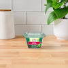 A single container of Gourmet Garden Basil (Case Of 72) sits on a light wood countertop, with a white tiled backsplash and a green plant in the background.