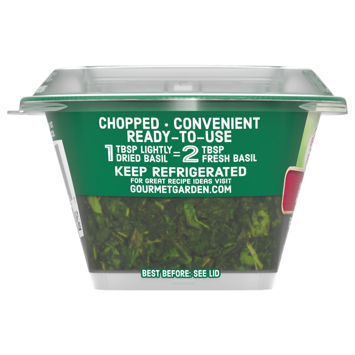 A clear container of Gourmet Garden Basil Seasoning Whole .42 Oz shows the chopped, ready-to-use herb inside, with a green label that includes the instruction to Keep Refrigerated.