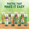 A variety of tubes of Dorot Gardens pastes are displayed, highlighting the convenience of using these pastes in cooking.