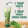 A tube of Gourmet Garden Green Onion Paste is shown, with text indicating that 1 tablespoon of the paste is equivalent to 1 tablespoon of fresh green onion.