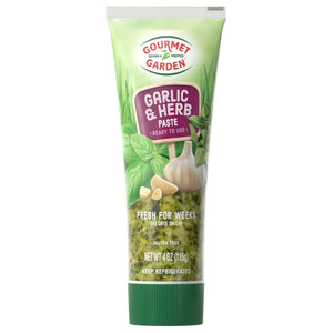 Gourmet Garden Garlic &amp; Herb Paste tube with a green background and a garlic clove on top.