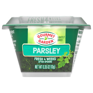 A clear container of Gourmet Garden Parsley Seasoning Chopped .35 Oz is shown, highlighting the lightly dried parsley inside.