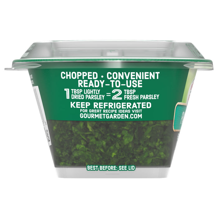 A side view of a container of Gourmet Garden Parsley Seasoning Chopped .35 Oz shows the chopped parsley inside and highlights the ready-to-use convenience on its green label.