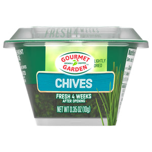 A clear plastic container of Gourmet Garden Chive Seasoning Chopped .35 Oz is shown against a white background, highlighting the lightly dried chives inside.