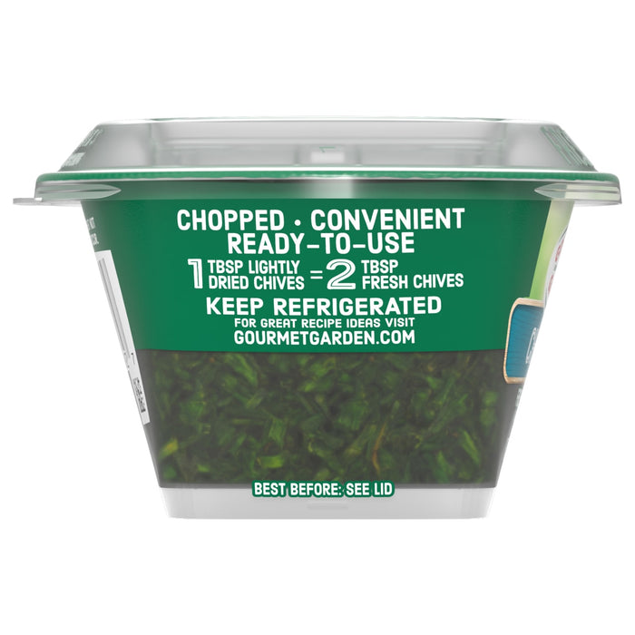 A side view of a container of Gourmet Garden Chive Seasoning Chopped .35 Oz shows the chopped chives and the label with usage and storage instructions.