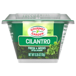 A clear plastic container of Gourmet Garden Cilantro Seasoning Chopped .35 Oz is shown against a white background, highlighting the product's packaging and branding.