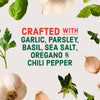 Image promoting a product crafted with garlic, parsley, basil, sea salt, oregano, and chili pepper, surrounded by fresh herbs and garlic cloves.