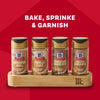 A Mccormick Finishing Sugar Caddy 4Ct is displayed against a red background, featuring four bottles of finishing sugar: Cinnamon Roll, Vanilla Cake, Chocolate Hazelnut, and Salted Caramel.