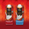 Two cartons of Thai Kitchen Simple Coconut Milk, one original and one unsweetened, are displayed against a red background.