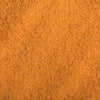 A close-up texture of fine, orange-colored sand.