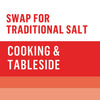 The image promotes using the product as a substitute for traditional salt in both cooking and at the table.