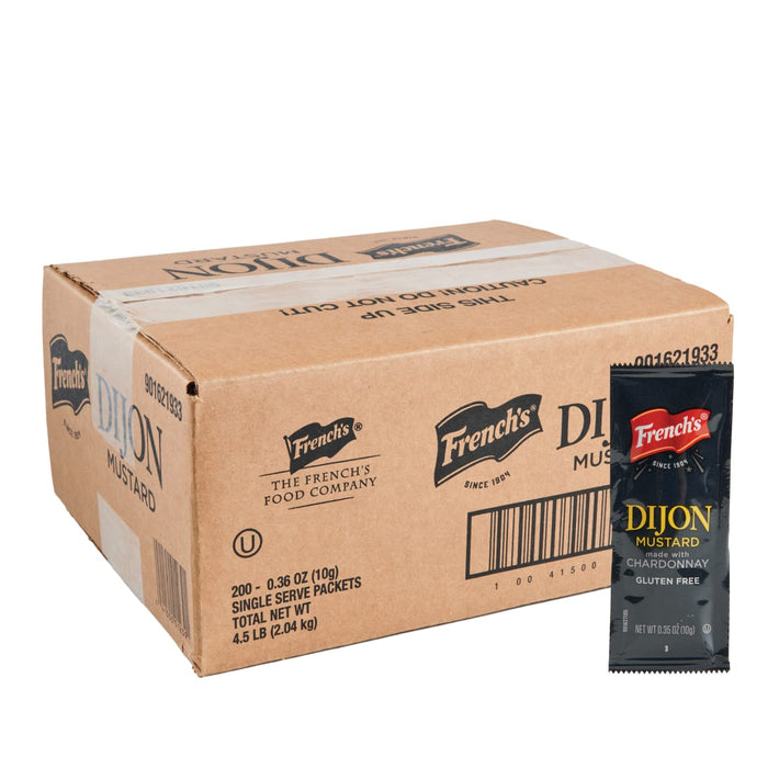 A cardboard box containing French'S Dijon Mustard 200/10 G single-serve packets, with one black packet featuring the French's logo and product name standing upright beside it.