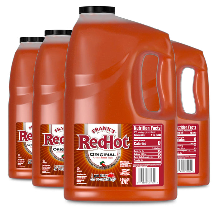 A product shot shows four large, one-gallon jugs of Franks Red Hot Original Cayenne Pepper Hot Sauce Red Hot 128 Oz arranged in a row against a white background.