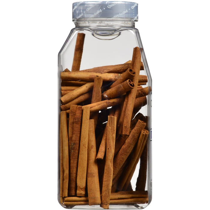 A glass jar filled with cinnamon sticks.