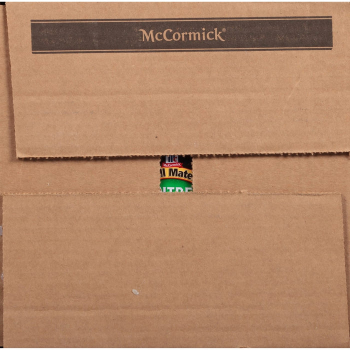 A close-up of a brown cardboard box with a McCormick All Mate can peeking out from the top.