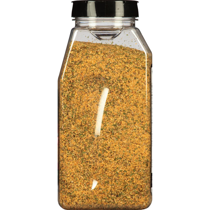 A glass jar filled with a yellow and green spice blend.