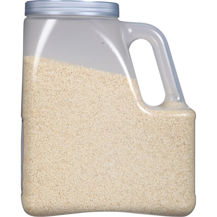A plastic container filled with white sesame seeds.
