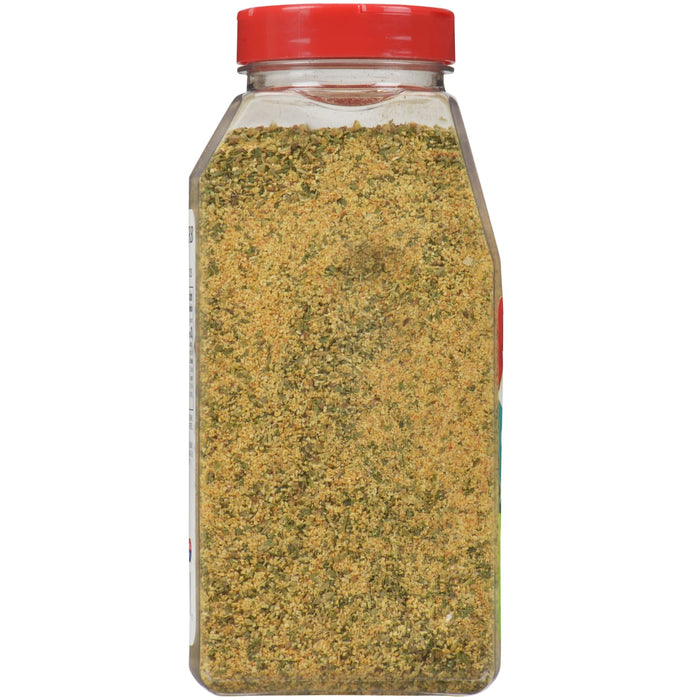 A glass jar of seasoning with a red lid.