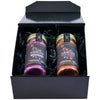 A black gift box displays two McCormick Flavor of the Year 2026 products, including the Mccormick Culinary Sweet &amp; Smoky Naturally Flavored Black Currant Seasoning and a Black Currant Finishing Sugar, nestled in black paper shred.