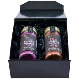 A black gift box displays two McCormick Flavor of the Year 2026 products, including the Mccormick Culinary Sweet &amp; Smoky Naturally Flavored Black Currant Seasoning and a Black Currant Finishing Sugar, nestled in black paper shred.