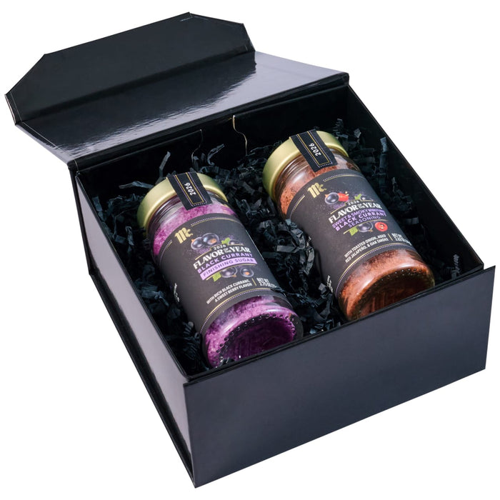 An open black gift box displays two McCormick Flavor of the Year products, including a jar of Mccormick Culinary Sweet &amp; Smoky Naturally Flavored Black Currant Seasoning, 28.0 Oz, and a jar of Black Currant Finishing Sugar.